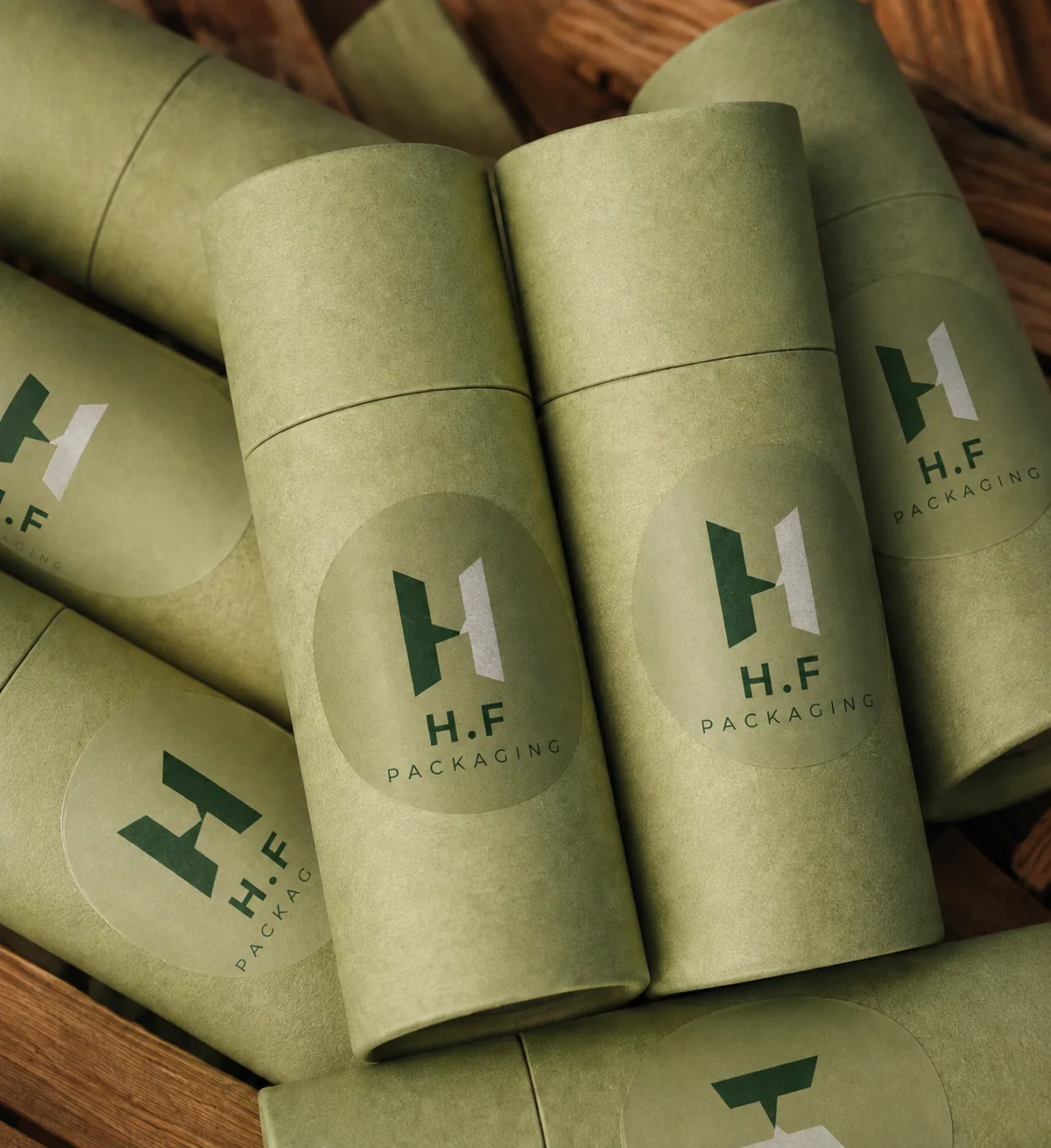 Sage green custom paper tubes with H.F Packaging logos
