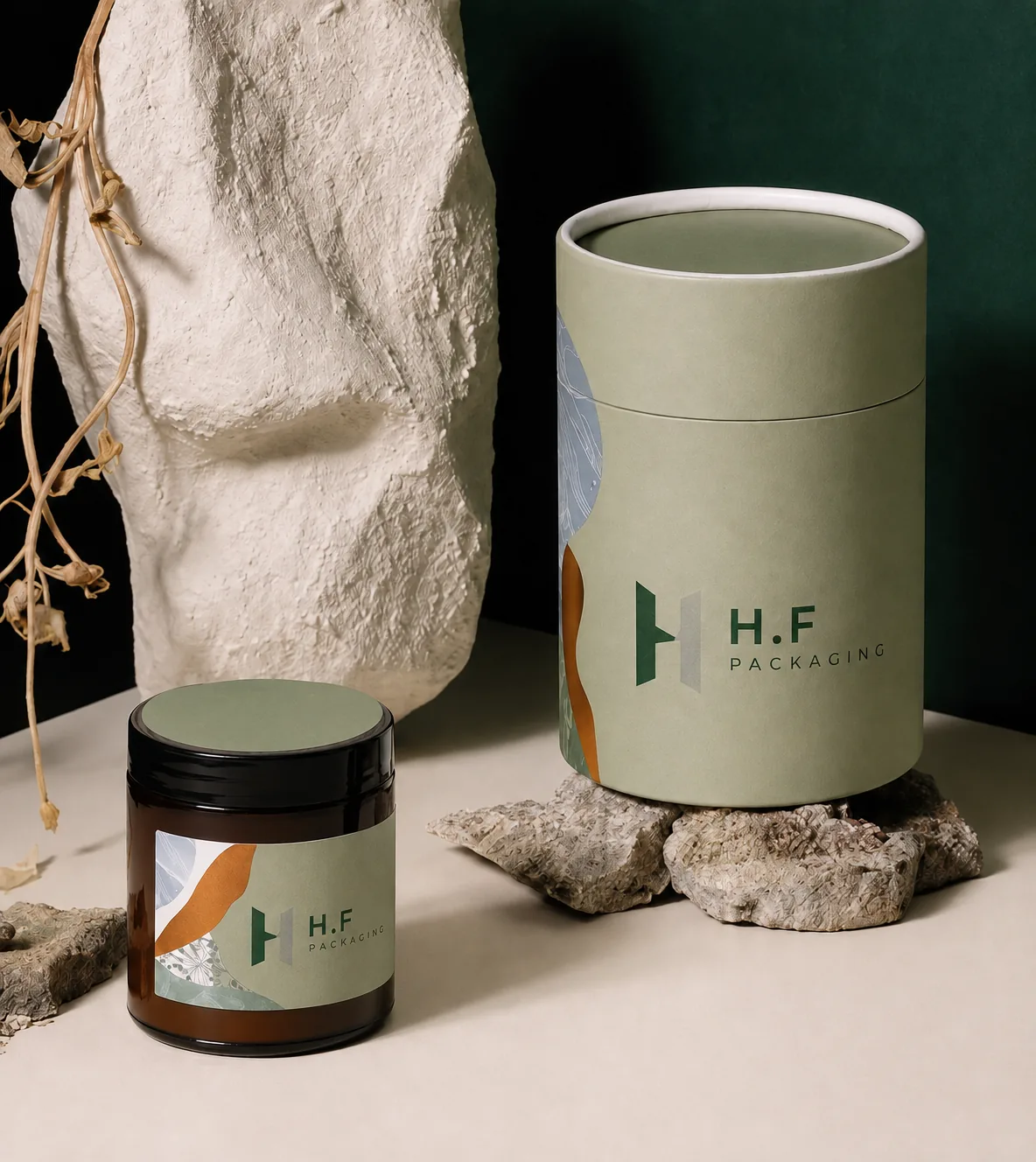 Sage green rigid paper tube and matching jar with H.F Packaging logos